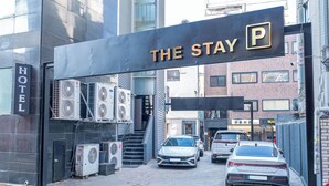 A hotel entrance with a sign reading "THE STAY P" and a "HOTEL" sign on the left. - The Stay (Seoul)