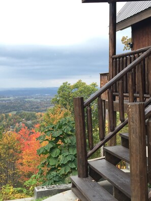 A wooden staircase leading to a viewing platform with a scenic view of a valley and autumn foliage. - Peekin'Over Pigeon Forge 3 bedroom, 3 bath cabin (Sevierville)
