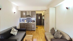 A modern apartment with a living area, kitchenette, and a small dining space. - New Gudauri Redco Apt. | Comfort by Wehost (Gudauri)