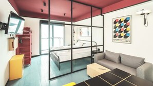 A modern room with a bed, a sofa, a desk, and a TV. - Super Stylish Apartment In New Gudauri -By Wehost (Gudauri)