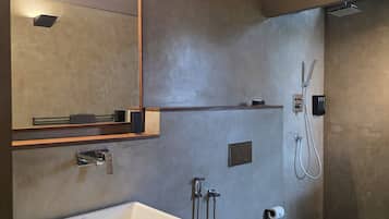 A modern bathroom with a large rectangular sink, a toilet, and a shower area.