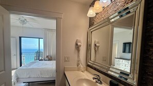 A hotel bathroom with a large mirror, a sink, and a ceiling fan. - All Bedrooms w/ Balcony & Golf Views on the 15th Floor, Free Golf Daily (Panama City Beach)