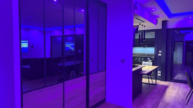 A modern interior with glass partitions, a dining area, and a kitchen. - Magnificent luxury loft with top-of-the-range amenities. (Montussan)