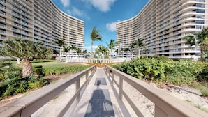 A modern hotel with a central courtyard, featuring a symmetrical design with two large buildings on either side. - South Seas Beachfront Haven (Marco Island)