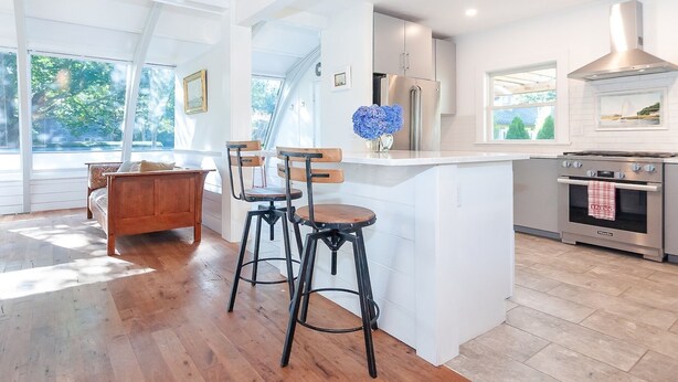 A modern kitchen with a large island, stainless steel appliances, and a view of the outdoors. - Relaxing Cape Cod Stay in a Charming Osterville Setting RPAM121 (Osterville)