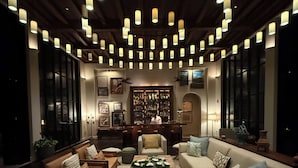 A cozy living room with a fireplace, comfortable seating, and a bar area.