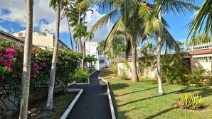 A pathway leading to a building with a sign reading "Residence Soleil". - Comfortable studio with terrace, cistern and pool access (Le Gosier)