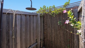 A wooden fence with a metal showerhead attached. - Bluwren: 4  BR, 2.5  BA House in South west rocks, Sleeps 6 (South west rocks)
