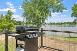 An outdoor grill with a view of a lake and trees. - Snowmobile, Fish & Relax: Mink Lake Retreat (Buffalo)