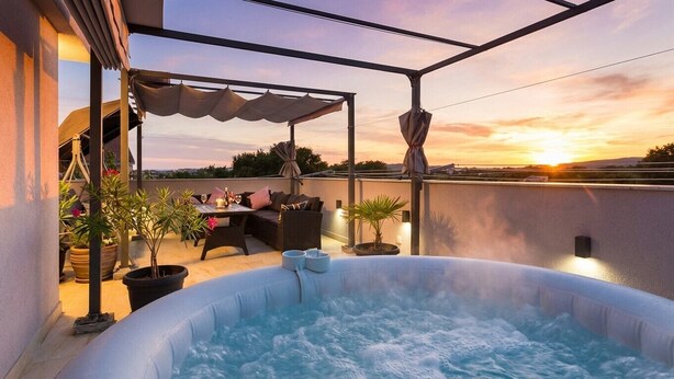 A hot tub with a patio area, outdoor seating, and a sunset view. - Stylish Duplex with Private Jacuzzi (Ližnjan)