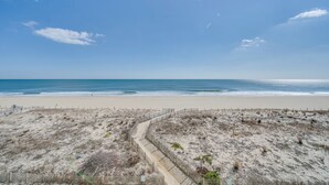 A sandy beach with a wooden pathway leading to the ocean. - Ocean view condo Seaside Vacations & Sales (Ocean City)
