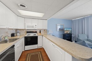 Fridge, microwave, oven, stovetop - Stunning oceanfront condo by Seaside Vacations & Sales (Ocean City)