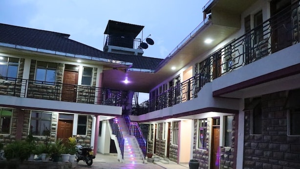A multi-story building with a central staircase, balconies, and a paved courtyard. - The Haven Luxury Guest House moyale (Moyale)