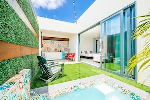 A modern outdoor area with a pool, a dining area, and a bedroom visible through a glass door. - 1 BDRM Suite for Any Budget, Private In-Suite Plunge Pool, Near Eagle Beach (Oranjestad)