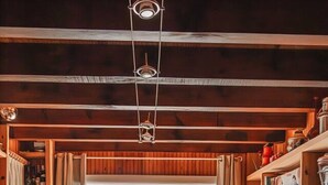 Un intérieur en bois avec une table à manger, des étagères et une vue sur l’extérieur.