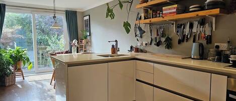 Dishwasher, coffee/tea maker, cookware/dishes/utensils, dining tables