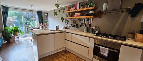 Dishwasher, coffee/tea maker, cookware/dishes/utensils, dining tables