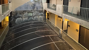A building with a mural on the wall, multiple balconies, and a staircase leading to an upper floor. - GoBravo Residences – Kapashera, New Delhi (New Delhi)