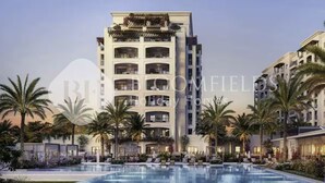 A multi-story hotel with a pool area, palm trees, and a clear sky. - 224-Bloomfields Modern Stu Yas Golf  (Abu Dhabi)