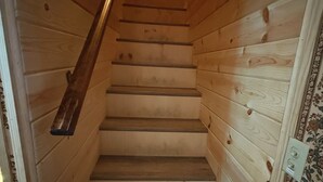 A wooden staircase with a handrail, leading to a landing. - Goldilocks Mountain Vibes for All Your Bears - No Better than Our Relaxing Mountain Vibes Cabin, 3BR for Mamma, Papa, and Baby Bears! (Big Bear)