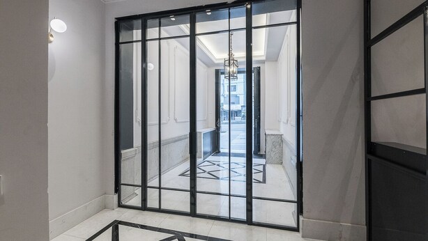 A modern interior with a sliding glass door leading to a hallway with a geometric floor pattern. - Alcala IX - Three Bedroom Apartment, Sleeps 6 (Madrid)