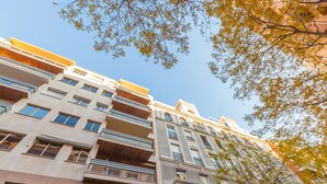 A multi-story building with balconies, large windows, and a classical architectural style. - General Pardiñas III (Madrid)