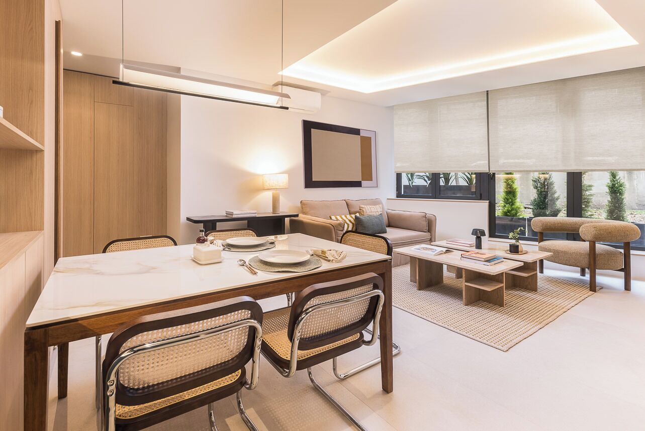 A modern living room with a dining area, a sofa, and a coffee table.