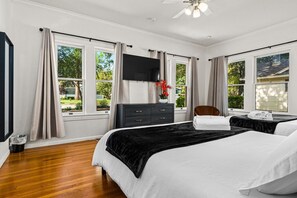 A bedroom with two beds, a TV, a dresser, and a chair. - San Antonio Resort Home | Pool, Hot Tub, Casita & Game Room (San Antonio)