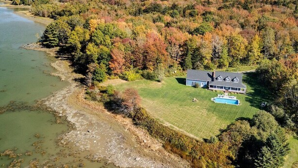 An aerial view of a house with a large lawn, a swimming pool, and a river nearby. - Cove House with Private Pool, Ocean Views, Family (Owls Head)