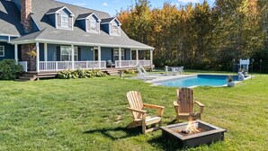 A house with a large deck, a swimming pool, and a fire pit area. - Cove House with Private Pool, Ocean Views, Family (Owls Head)