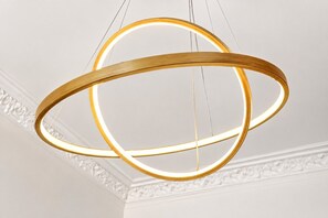 A pendant light fixture with a circular design and a glowing interior. - Stunning 1-Bedroom Flat in Edinburgh | Sleeps 3 (Edinburgh)