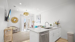 A modern kitchen with a central island, a built-in dishwasher, and a sink. - Extended Stay Friendly-Full Kitchen & Laundry (Pass Christian)