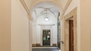 A hallway leading to a door labeled "PORTIER." - Cestari Luxury Terraces (Rome)