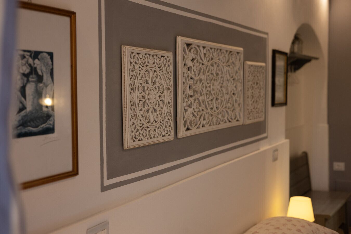 Un corridoio con pannelli decorativi e opere d'arte incorniciate alle pareti.