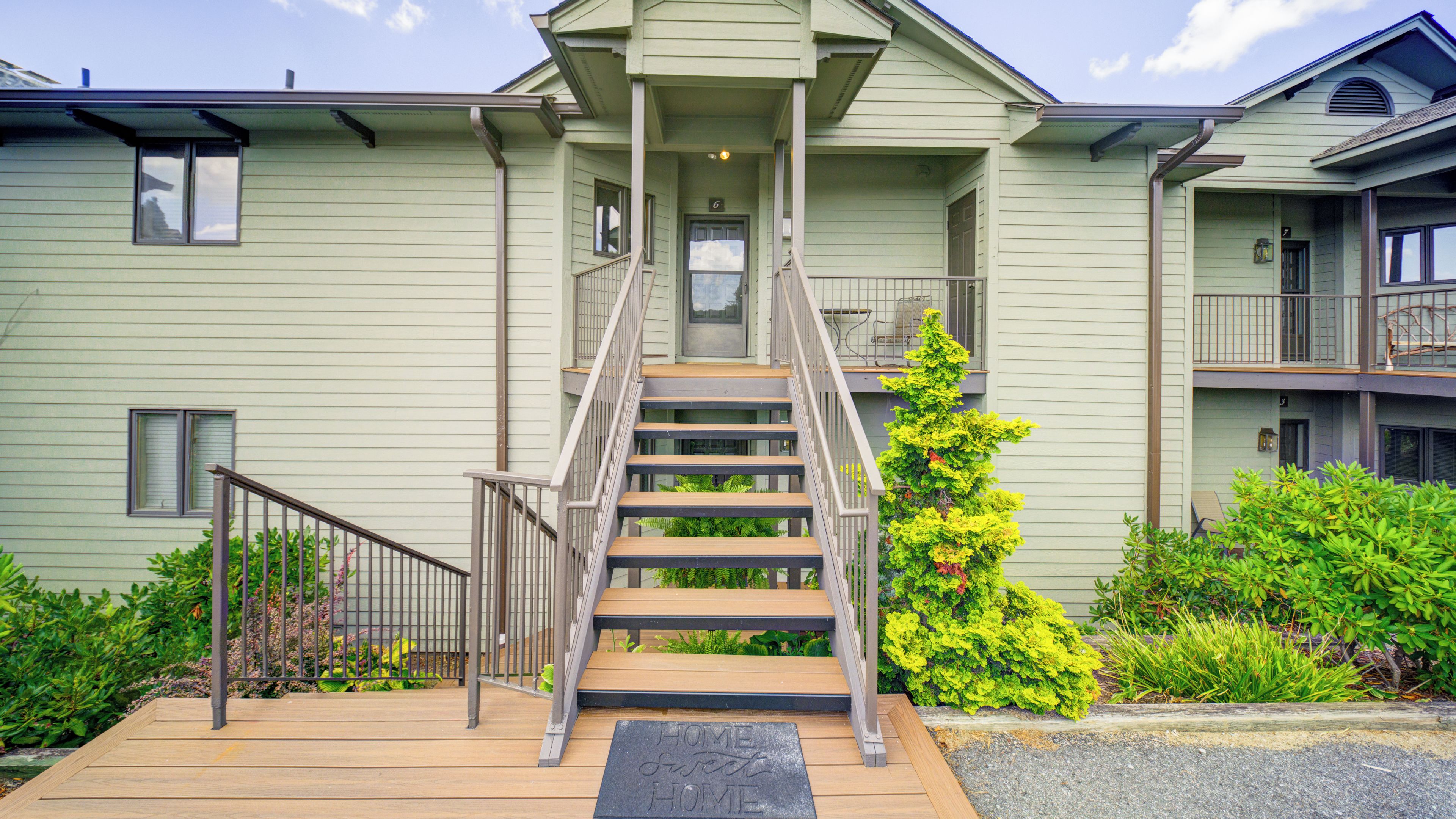 A multi-story building with a central staircase leading to the entrance.