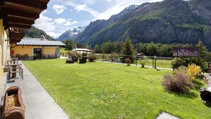 Blick auf Berge mit einem Gebäude, Außenbereich und einem Schild für 'LA BAITA Apartments'.