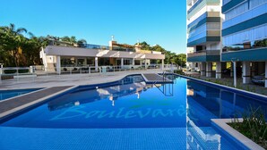 A modern hotel with a swimming pool, outdoor seating, and a clear blue sky. - Boulevard Praia de Palmas a 400m do Mar (Governador Celso Ramos)