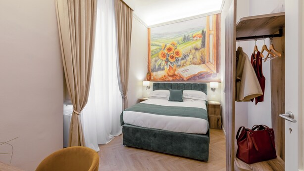 A hotel room with a bed, a wardrobe, a chair, and a painting on the wall. - Hotel Settefiori (Florence)
