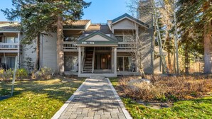A two-story house with a front porch, a visible address, and a pathway leading to the entrance. - Snowcreek IV 559 | Dog Friendly (Mammoth Lakes)