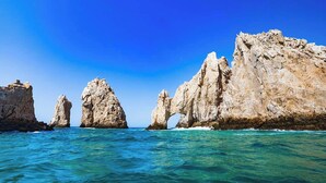 A coastal landscape with prominent rock formations and clear blue waters. - Cozy 1-bedroom luxe hotel suite in magnificent and fun Cabo San Lucas. (Cabo San Lucas)