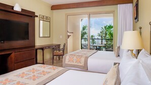 A hotel room with two beds, a desk, a chair, a TV, a balcony with a view of palm trees and the sea. - Cozy 1-bedroom luxe hotel suite in magnificent and fun Cabo San Lucas. (Cabo San Lucas)