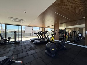 A gym with treadmills, stationary bikes, and weight machines. - Noroeste design comfort and charm (Brasília)