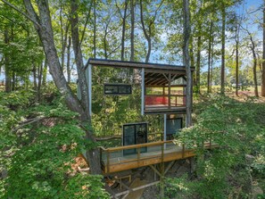 A wooden observation tower with a viewing platform, surrounded by dense forest. - The Star Wars Treehouse (Rockbridge)