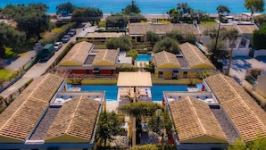 A coastal hotel with multiple buildings, a swimming pool, and a view of the sea. - Barbati Beach - Villa Lefkada (Barbati)