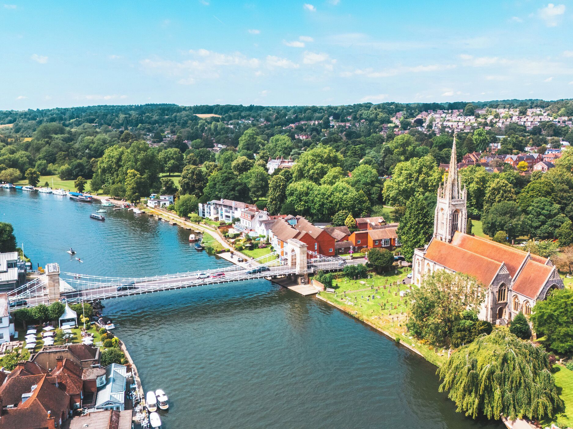 A riverside town with a prominent church, a bridge, and residential buildings.