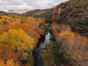 A river flowing through a canyon with autumn foliage. - The Joy Sedona  (Sedona)