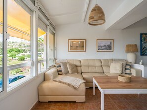 A living room with a beige sofa, a wooden coffee table, and a hanging wicker lamp. - New Sweden By CanariasGetaway (San Bartolomé de Tirajana)
