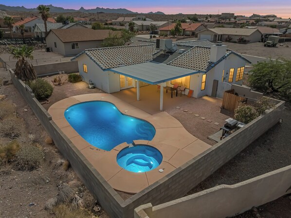 A house with a swimming pool, a covered patio, and a view of the surrounding neighborhood. - Private Pool, Home Away From Home! (Bullhead City)