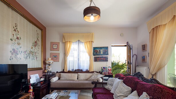 Ein Wohnzimmer mit Fernseher, Sofa und Couchtisch.