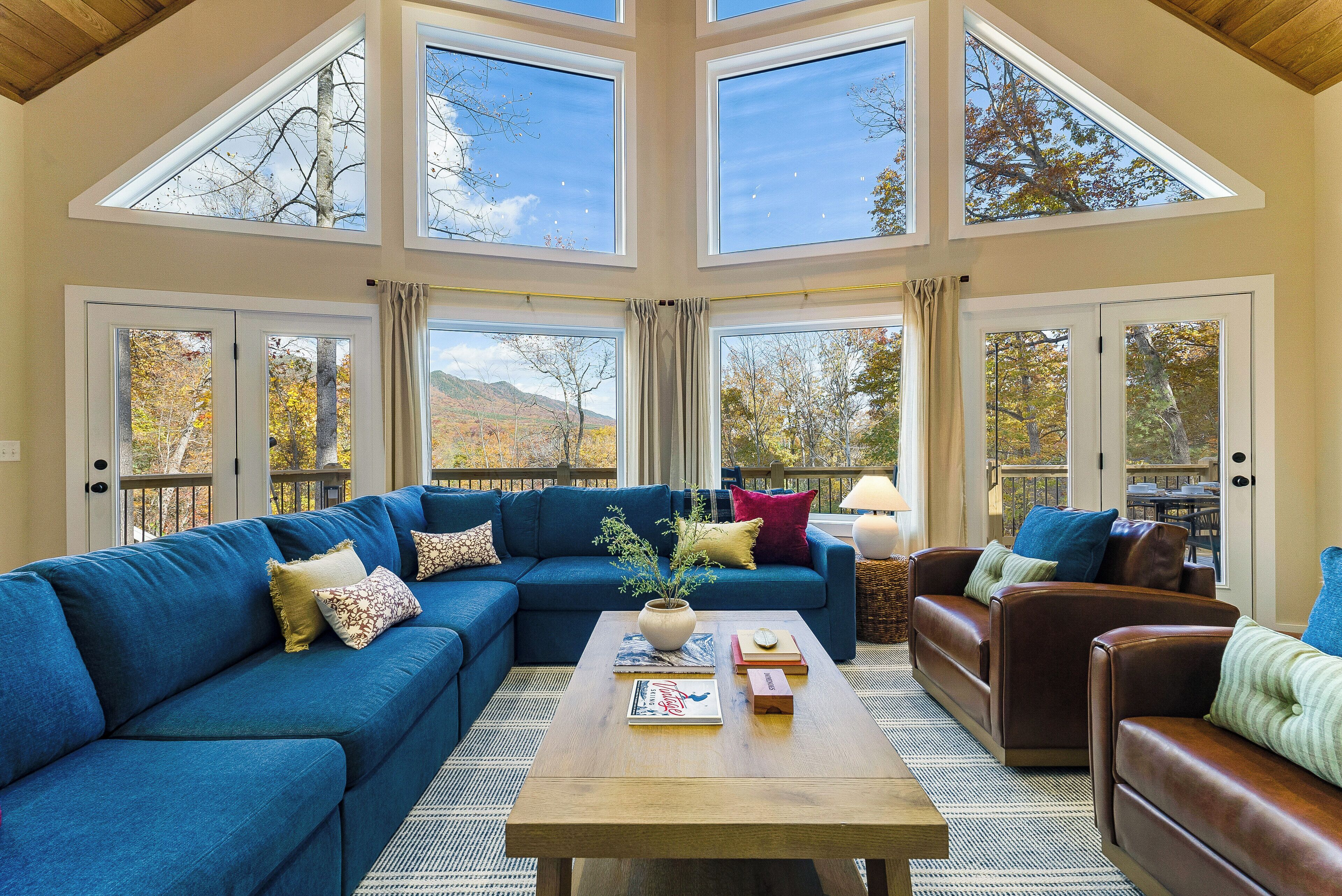 A spacious living room with a sectional sofa, a coffee table, and a fireplace.